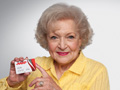 Betty White holding AARP membership card