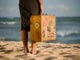 woman carrying suitcase on beach woman carrying suitcase on beach