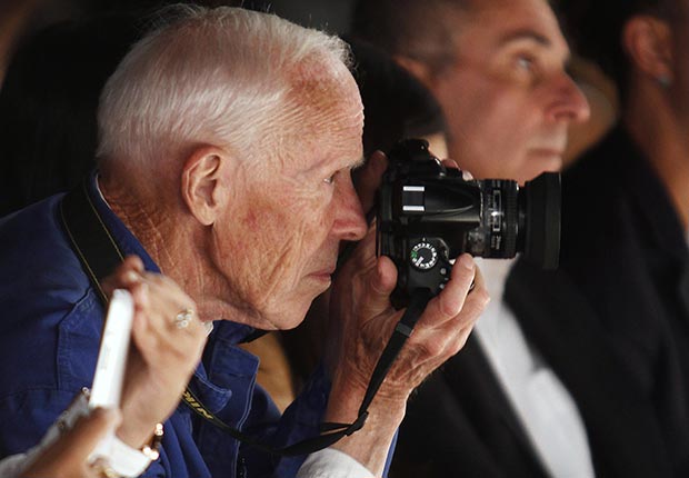 New York Times photographer Bill Cunningham takes photos during the Naeem Khan Spring/Summer 2013 collection show at New York Fashion Week September 11, 2012