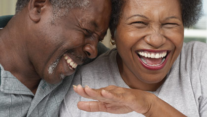 Mature couple laughing - good news websites share positive news over doom and gloom