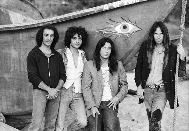 Rock band Crazy Horse. From left to right, Ralph Molina, Billy Talbot, Frank “Poncho” Sampedro and Neil Young on Malibu Beach in 1975