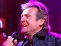 Davy Jones, former member of the band The Monkees, performing on stage 	