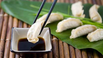Chopsticks with Gyoza dumplings and soy sauce Chopsticks with Gyoza dumplings and soy sauce