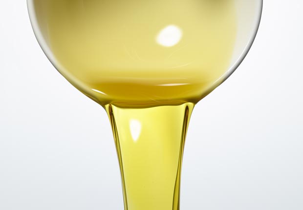 Olive Oil being poured out of bowl