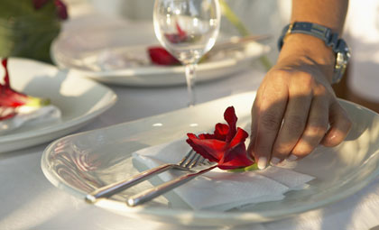 placing flower on dinner plate