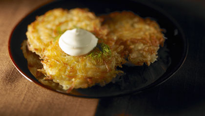 Three potato latkes with sour cream