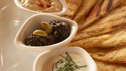 Flatbread with tzaziki, hummus and black olive tapenade
