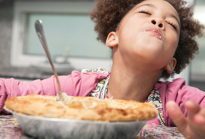 child eating pie
