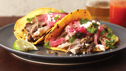 Pernil, a savory Puerto Rican pork roast served on tortillas. Pernil, a savory Puerto Rican pork roast served on tortillas.