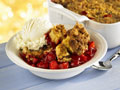 Bowl of strawberry cobbler with ice cream