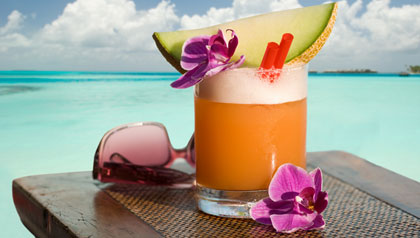 Fruity cocktail and sunglasses on a table on the beach. Fruity cocktail and sunglasses on a table on the beach.