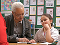 Senior man explains book to child, AARP Experience Corps