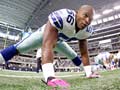 Dallas Cowboys linebacker Bradie James (56) wears pink gloves and cleats to honor NFL Breast Cancer Awareness Month.