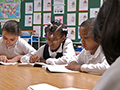 Children doing schoolwork, AARP Experience Corps In the News