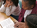 A woman reading to two girls, AARP Experience Corps Contact