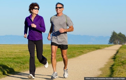 Smiling couple jogging on path, Exercise helps brain health