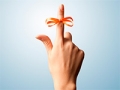 Red bow on index finger (iStockPhoto)
