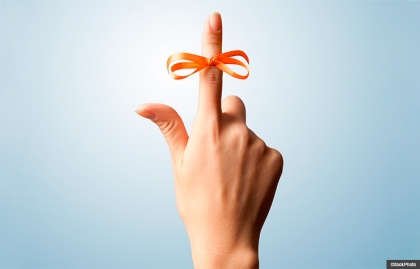Red bow on index finger (iStockPhoto)