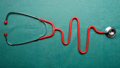 A stethoscope in the shape of a normal EKG graph