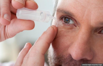 Mature man applying eye drops into eye, Three Eye Diseases of Aging
