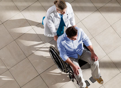 nurse pushing patient in wheel chair nurse pushing patient in wheel chair
