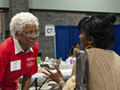 volunteer helps patient at free health clinic