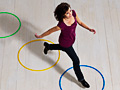 Woman jumping over circles