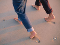 two people walking on the beach
