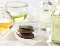 olive oil, green tea, and cider vinegar in glass containers