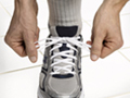 lacing up athletic shoe - New study suggests that middle-aged adults recently diagnosed with diabetes and hypertension may have more time to try to control their high blood pressure without medications.