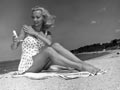 Young Woman; Beach; Sunblock; Suntan; Lotion; Summer; Sand; Face; SPF