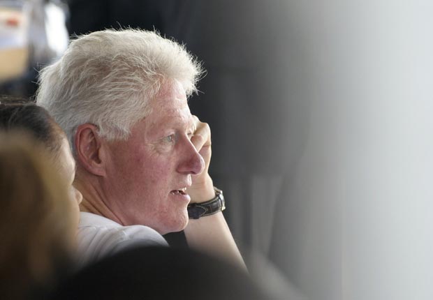 President Bill Clinton listens to Haitian President Michel Martelly