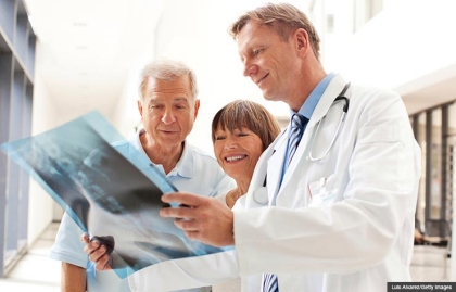 Doctor reviewing an x-ray image with patients