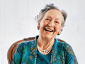 A happy woman shows a big smile. A positive attitude is good for your health.