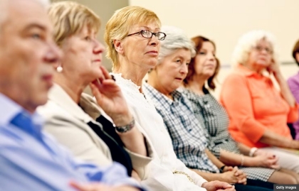 Group of mature adults sitting in a support group (Getty Images)