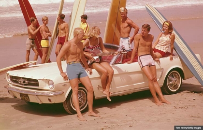 Surfers on beach with surfboards and Ford Mustang convertible, Boomer Cars Then and Now