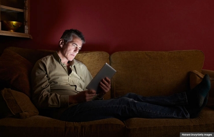 Man watching TV show on digital tablet.