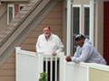 homeless veterans stand on their balcony in their development in Pittsfield, Mass.