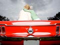 We Need To Talk - 07 - A couple sitting on top of a red convertible car.