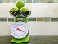 green apples on a scale