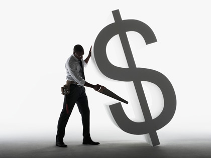 man sawing a dollar sign man sawing a dollar sign