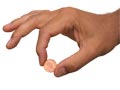 Hand holding a penny in the Savings Challenge Quiz
