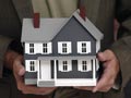 A man holding model house