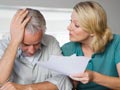Mature couple arguing about financial situation