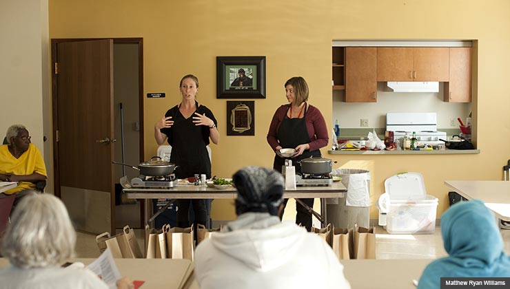Meghan Lyle, left, and Jennifer Hinson demonstrate recipes during a class for low-income people 50 and older. The ‘Pots and Plans’ class focuses on small, nutritious and affordable meals.