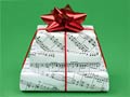 Regalos envueltos en hoja de música - 10 secretos para ahorrar en estas vacaciones Regalos envueltos en hoja de música - 10 secretos para ahorrar en estas vacaciones