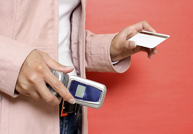 Woman holding phone and credit card