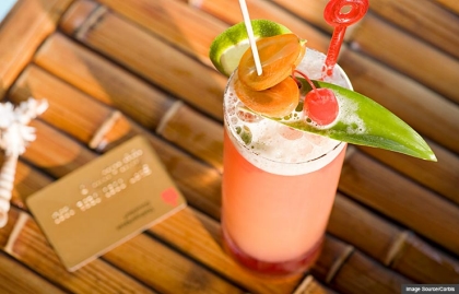Cocktail and credit card (Image Source/Corbis)