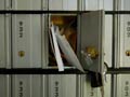 Un buzón de correo abierto con unas cartas adentro