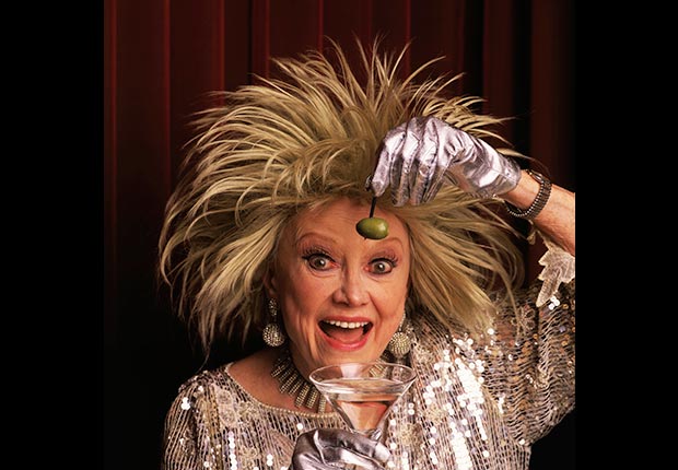 Comedienne Phyllis Diller holds olive and martini.  Diller died on August 20, 2012.